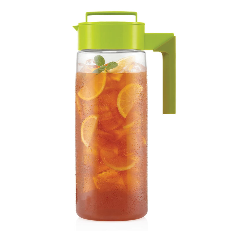 Refreshing homemade iced tea with lemon slices and fresh mint in a large clear pitcher with green airtight lid