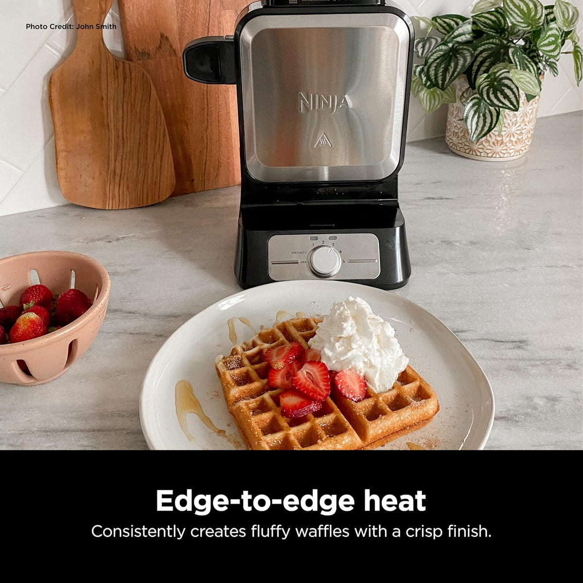Ninja vertical waffle maker on a counter with a finished waffle