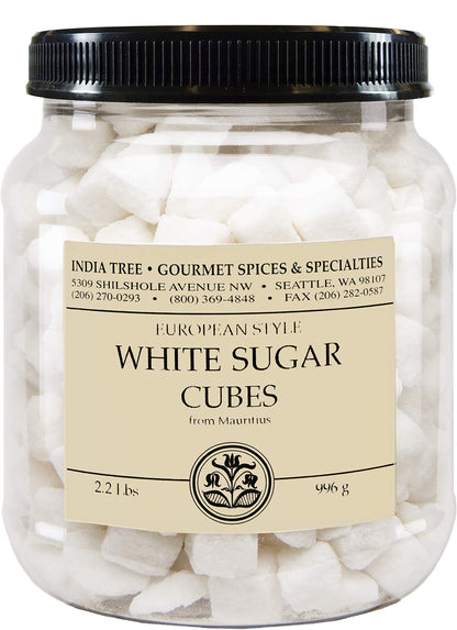 A clear plastic jar filled with white sugar cubes, topped with a black ribbed lid and a cream-colored label reading 'White Sugar Cubes' with the brand 'India Tree Gourmet Spices & Specialties'.