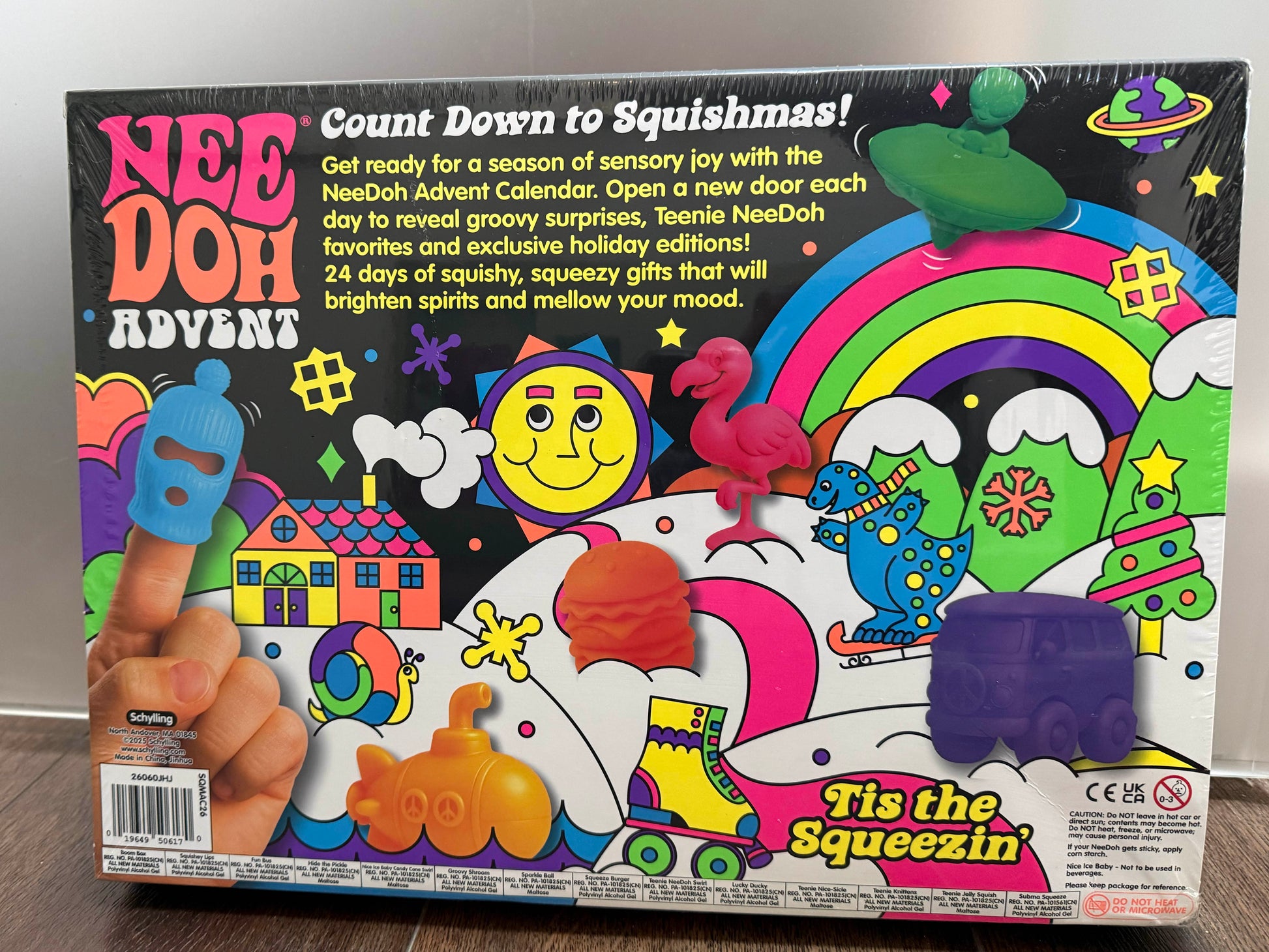 Nee Doh Advent toy box front cover, showing colorful illustrated graphics, a squeeze finger toy, and promotional text on a dark background.
