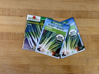Three seed packets on a wooden surface